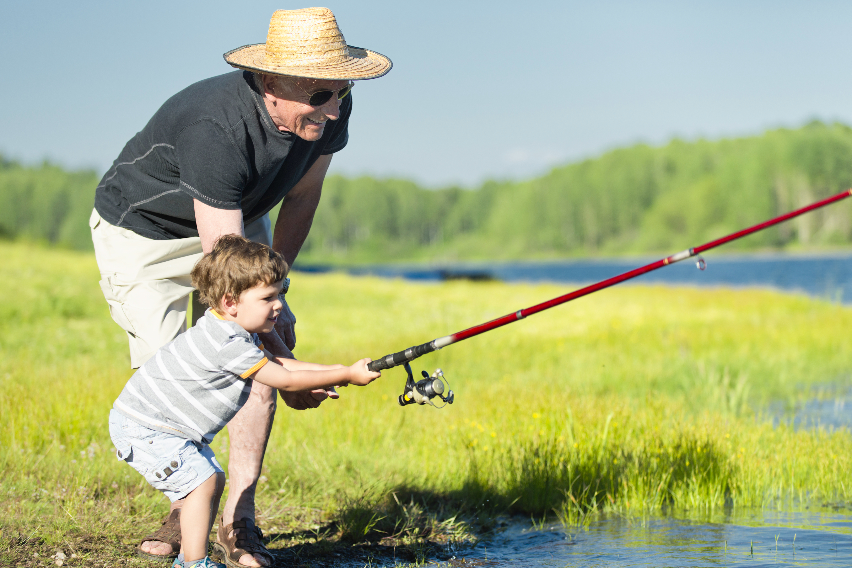 Grandfather fishing with grandchild